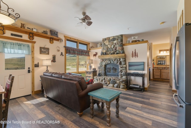14 Table Top Dr, Dubois, WY 82513 - living room with dark wood-type flooring, a ceiling fan, and a stone fireplace