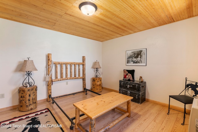 bedroom with light hardwood / wood-style floors and wood ceiling