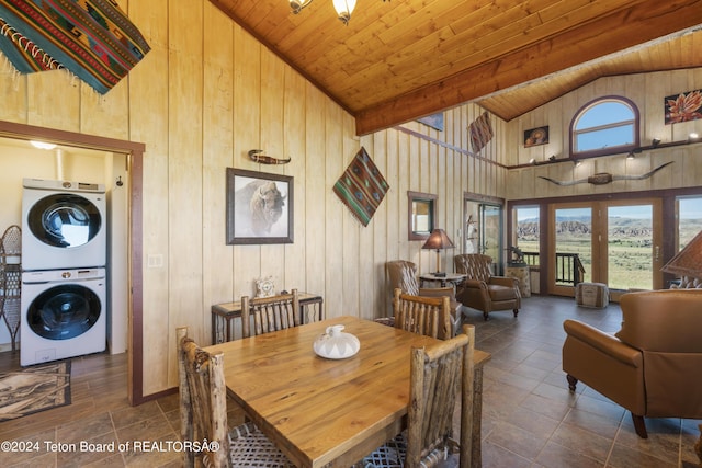 28 Table Top Dr, Dubois, WY 82513 - dining room with stacked washer / dryer, high vaulted ceiling, wood walls, and wooden ceiling with exposed beams