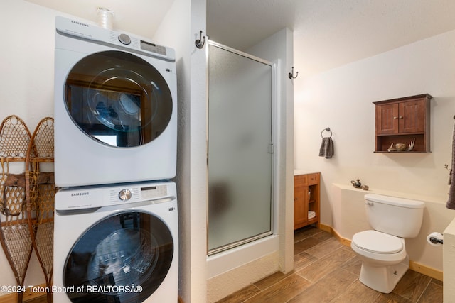 washroom featuring light wood-type flooring and stacked washer / drying machine