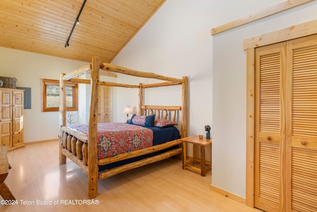 bedroom featuring track lighting, vaulted ceiling, light hardwood / wood-style flooring, and wooden ceiling