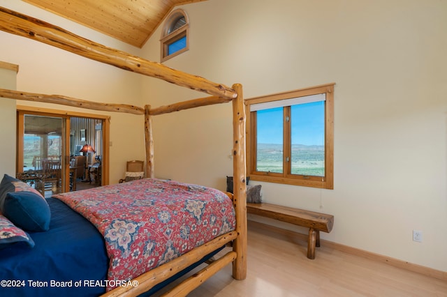 bedroom with wooden ceiling, multiple windows, lofted ceiling, and light wood-type flooring