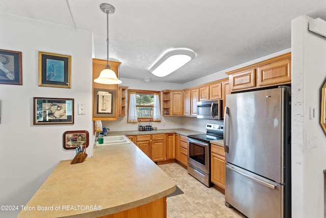 kitchen featuring light tile patterned floors, stainless steel appliances, hanging light fixtures, sink, and kitchen peninsula