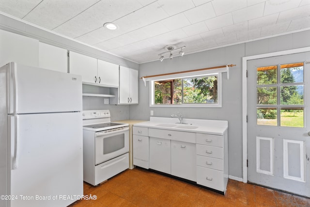 kitchen featuring tile patterned floors, white appliances, sink, and plenty of natural light