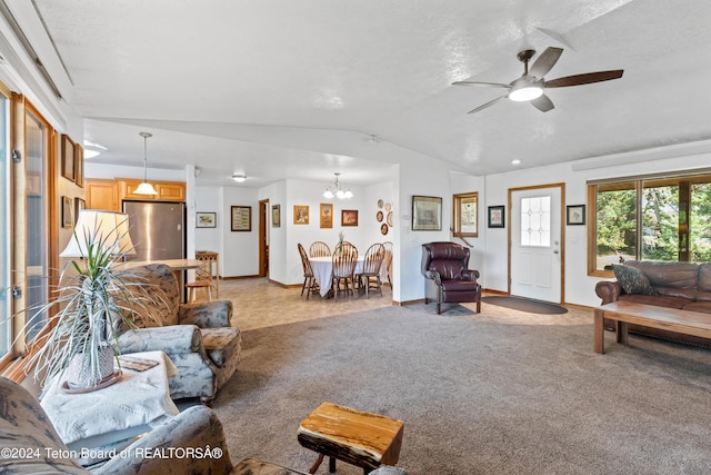 living room with baseboards, lofted ceiling, and ceiling fan with notable chandelier