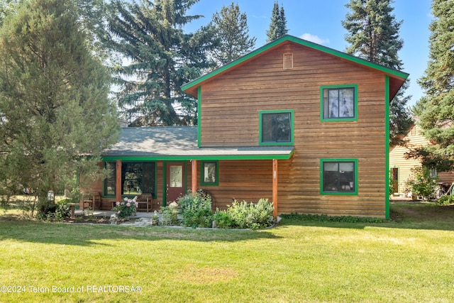 rear view of house with a lawn