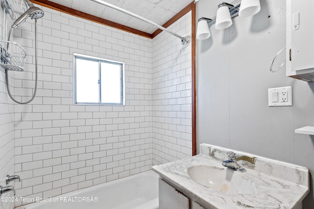 bathroom featuring tiled shower / bath combo and vanity