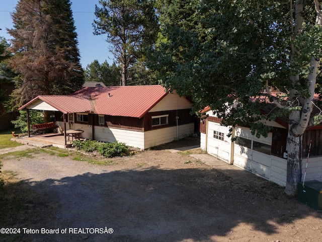 view of home's exterior with driveway and metal roof