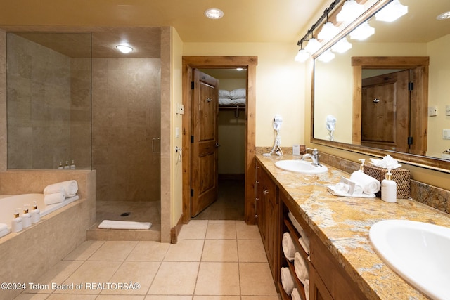 bathroom with tile patterned floors, separate shower and tub, and vanity