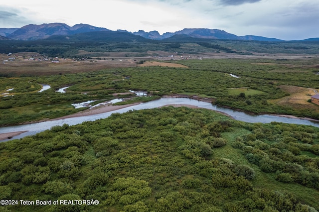 drone / aerial view featuring a water and mountain view