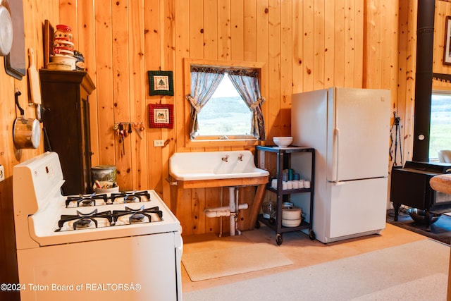 kitchen with wood walls and white appliances