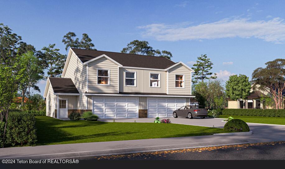 view of front of home featuring a garage and a front yard