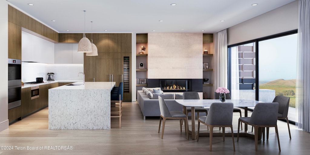 interior space featuring sink, light wood-type flooring, and a fireplace