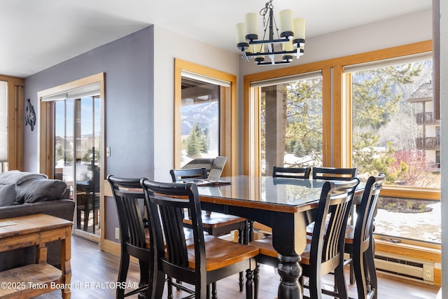 3600 W Michael Dr Unit D-4-2, Teton Village, WY 83014 - dining room with a chandelier, wood finished floors, and baseboard heating