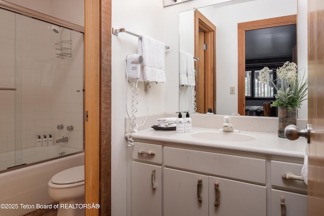3600 W Michael Dr Unit D-4-2, Teton Village, WY 83014 - bathroom featuring vanity, connected bathroom, enclosed tub / shower combo, and toilet