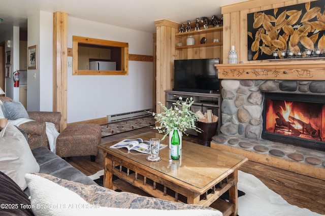 3600 W Michael Dr Unit D-4-2, Teton Village, WY 83014 - living area featuring a baseboard radiator, a fireplace, and wood finished floors