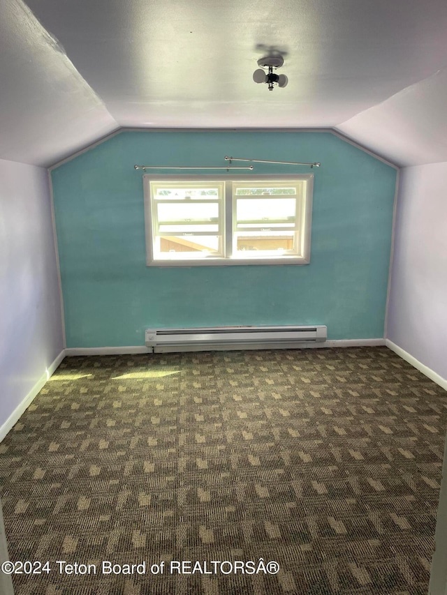 bonus room featuring a baseboard radiator, a healthy amount of sunlight, vaulted ceiling, and dark colored carpet