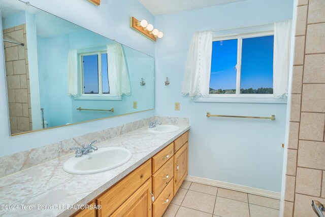 bathroom with tile patterned floors and vanity