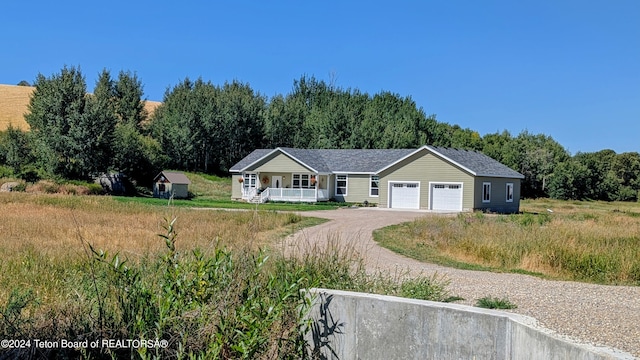 ranch-style home with a garage and a porch