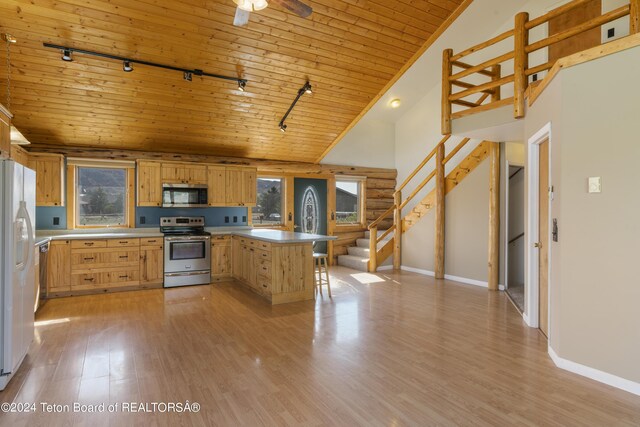 kitchen with high vaulted ceiling, track lighting, light hardwood / wood-style floors, wooden ceiling, and stainless steel appliances