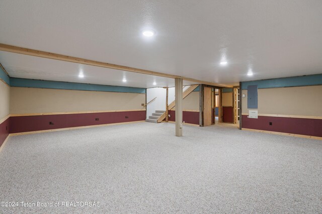 basement with carpet and electric panel