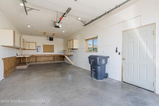 garage featuring a workshop area and a garage door opener