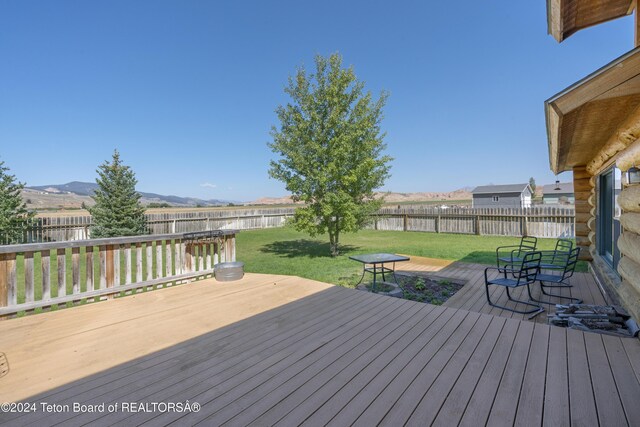 wooden deck with a lawn