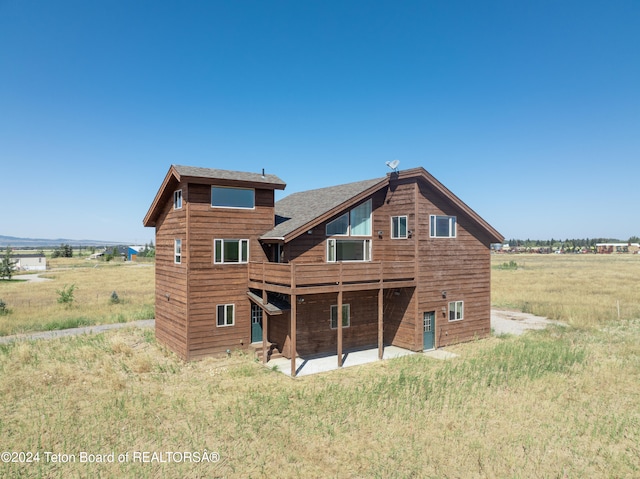 back of house with a rural view