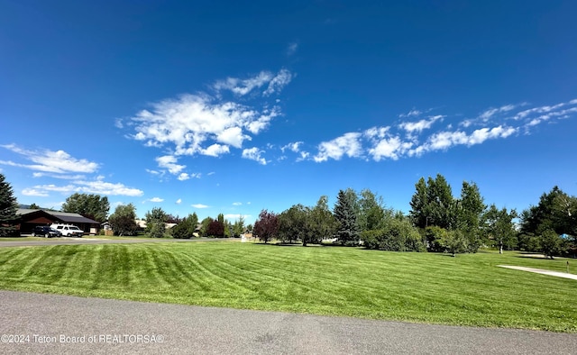 exterior space featuring a rural view and a yard