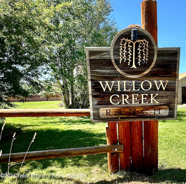 community / neighborhood sign featuring a yard