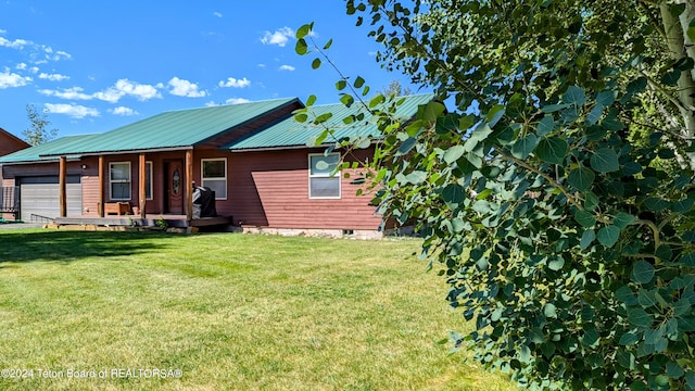 view of front of home with a garage and a front yard