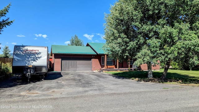 view of front of property with a front lawn and a garage