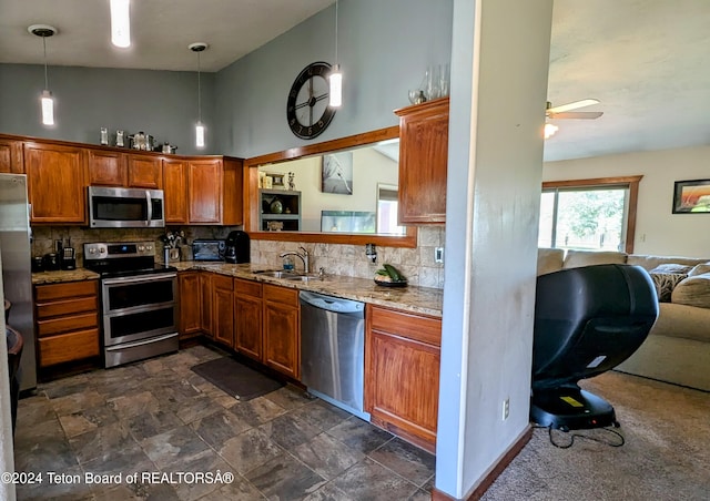 kitchen featuring ceiling fan, backsplash, high vaulted ceiling, light stone counters, and stainless steel appliances