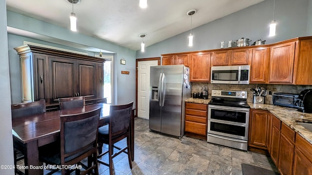 kitchen featuring decorative light fixtures, decorative backsplash, light stone countertops, stainless steel appliances, and lofted ceiling