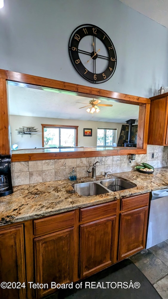 kitchen with sink, dishwasher, ceiling fan, and decorative backsplash