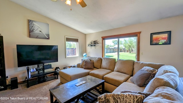 living room featuring ceiling fan, carpet floors, and vaulted ceiling