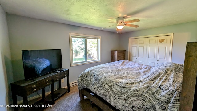 carpeted bedroom with ceiling fan, a closet, and baseboard heating