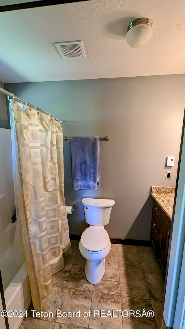 full bathroom with tile patterned flooring, shower / bath combination with curtain, vanity, and toilet