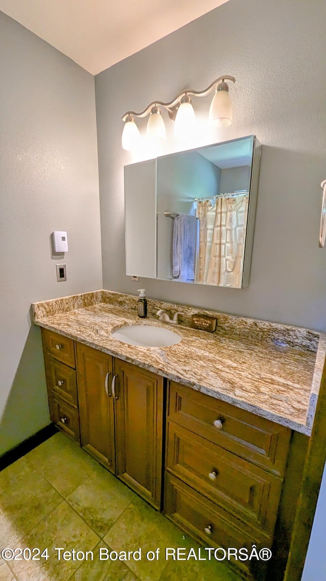 bathroom with tile patterned flooring and vanity