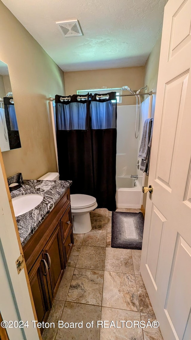 full bathroom with tile patterned flooring, toilet, shower / bath combo with shower curtain, and vanity