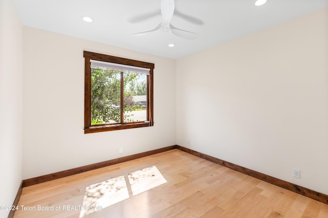 spare room featuring recessed lighting, light wood-style flooring, and baseboards