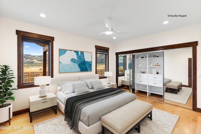 bedroom featuring light wood-style floors, multiple windows, and recessed lighting