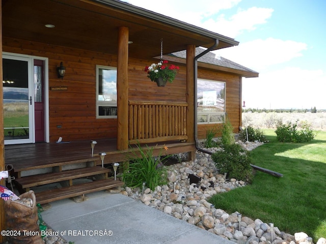 property entrance with a lawn