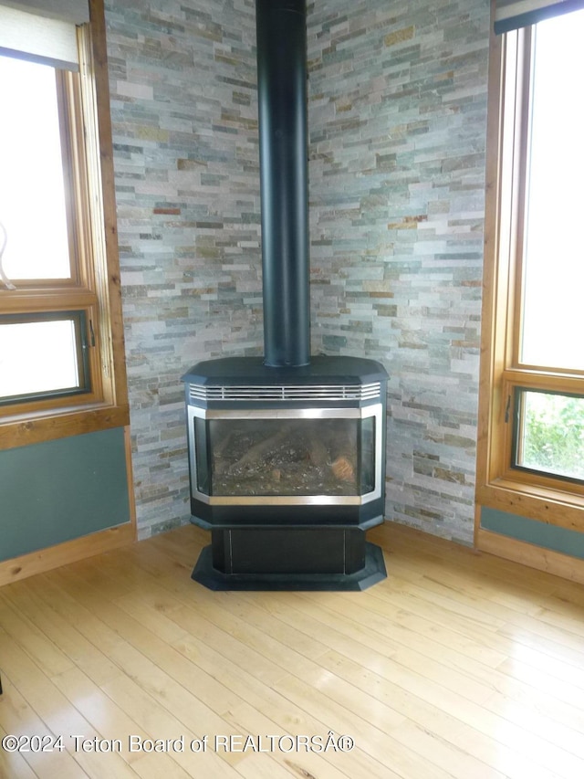 details featuring wood finished floors and a wood stove