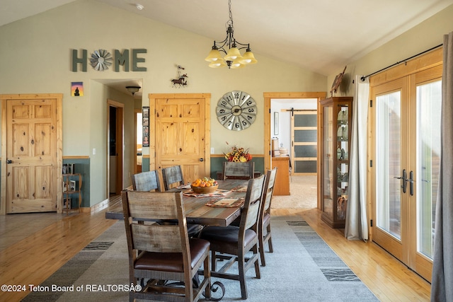 dining area with plenty of natural light, french doors, light wood-type flooring, and a notable chandelier