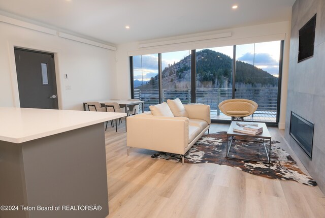 living room featuring plenty of natural light, light wood-style floors, and recessed lighting