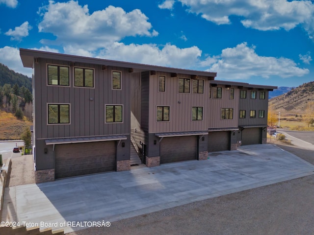 view of front of house featuring a garage, board and batten siding, and concrete driveway