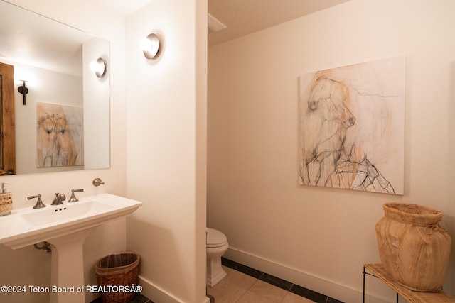 bathroom with tile patterned floors and toilet