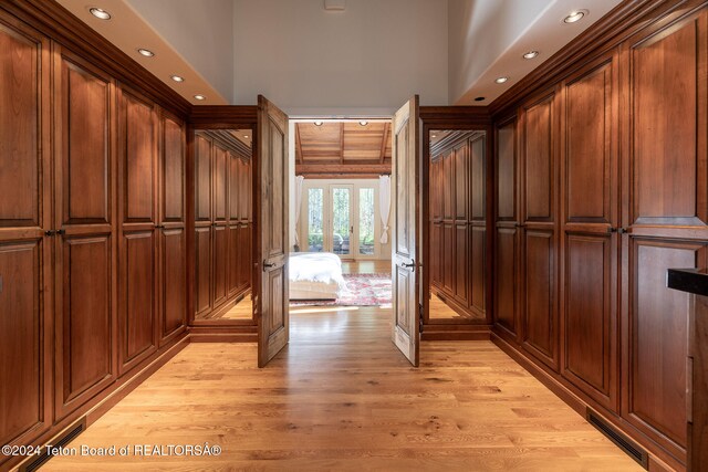 mudroom featuring light hardwood / wood-style floors, french doors, and a high ceiling