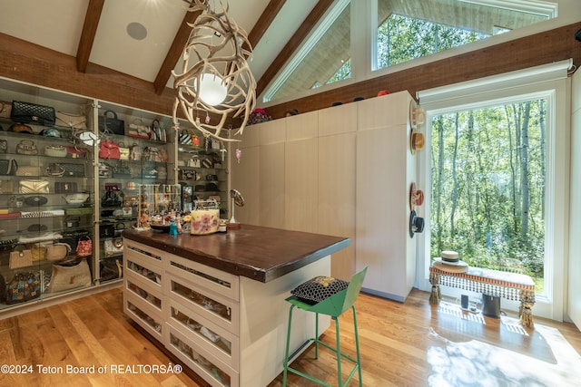 interior space with a center island, light hardwood / wood-style floors, and white cabinets